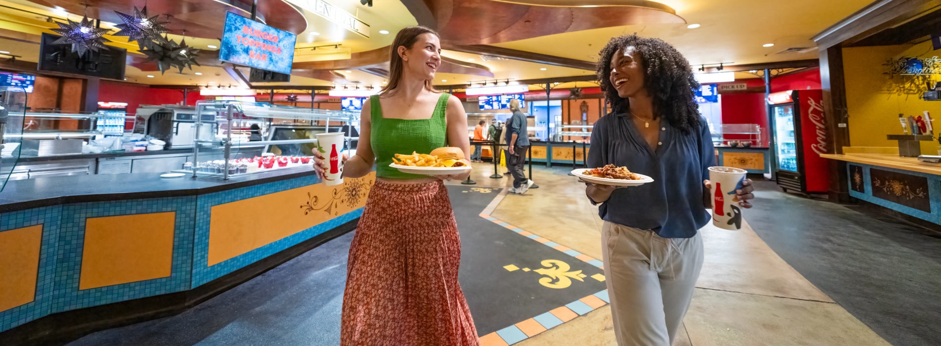 Two women holding food in Dragon Fire Grill at Busch Gardens Tampa Bay