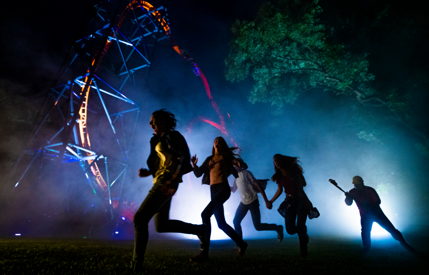 People running from a monster at Howl-O-Scream
