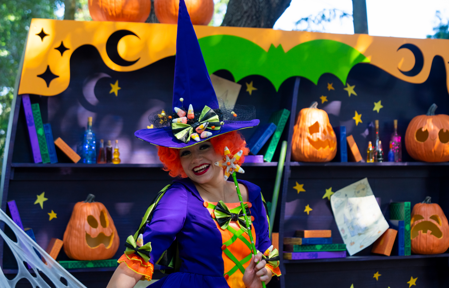 Colorful kid-friendly witch with purple hat and orange hair