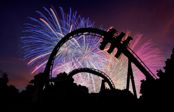 Fireworks behind a roller coaster