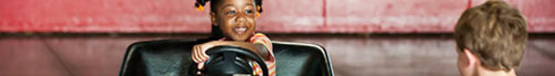 Two children riding bumper cars