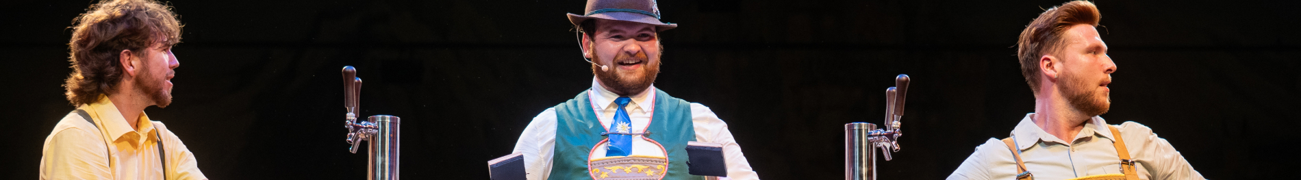 Three entertainers on stage for We Are Oktoberfest at Busch Gardens Williamsburg